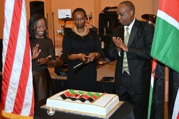 Jean Kamau cutting the cake to celebrate Kenya's 50th anniversary in Atlanta, Georgia