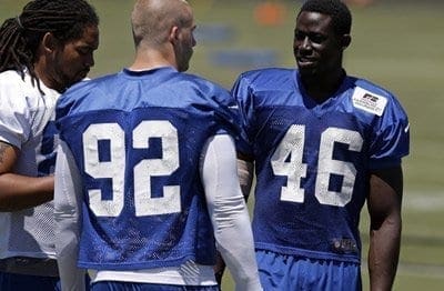 Indianapolis Colts linebacker Daniel Adongo, (right #46) with teammates during practice at the NFL team's football training camp in Anderson, Indiana, on July 29, 2013.