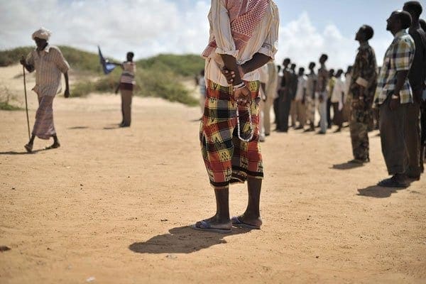 A Somali elder standing with his prayer beads during a demonstration by a local militia, April 30, 2014. Gunmen in Somalia shot dead a Kenyan teacher, police and witnesses said Thursday, in the latest attack to target foreigners in the restive central Galkayo region. AFP PHOTO / AU-UN IST / TOBIN JONES