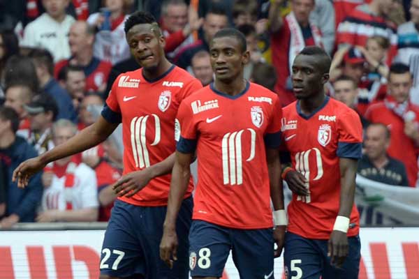 PHOTO | AFP Lille's Belgium forward Divock Origi (left) is congratulated by his teammates Ivorian forward Salomon Kalou (C) and Senegalese midfielder Idrissa Gueye after scoring a goal during the French L1 football match between Lille (LOSC) and Valenciennes (VA) on April 12, 2014 at the Grand Stade in Villeneuve-d'Ascq, outside Lille, northern France. Origi was named in Belgium's 24- man squad for the FIFA World Cup next month.