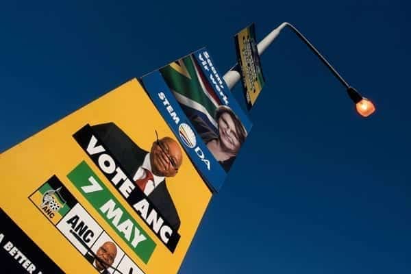Election posters with the faces of Jacob Zuma(in yellow), African National Congress(ANC) and South African President, and Helen Zille(in blue), opposition Democratic Alliance(DA), smiling out in Gugulethu on May 02, 2014. AFP / RODGER BOSCH