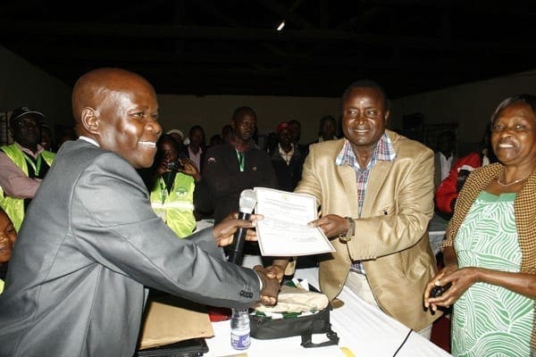 The new MP for Bonchari Constituency Mr Zebedeo Opore (centre) receives a certificate from the Returning Officer Mr Peter Refa (left) after being declared winner in the just concluded by-election. Political analysts Tuesday concurred that had ODM and Wiper put aside their internal differences and fielded one candidate, Cord could have won the race. PHOTO/JACOB OWITI