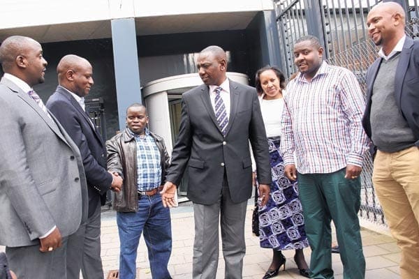 Deputy President William Ruto (centre) and  radio journalist Joshua arap Sang (third left) with well-wishers, among them Kericho Senator Charles Keter (second from left), at the ICC in The Hague on September 5, 2014. PHOTO | DPPS