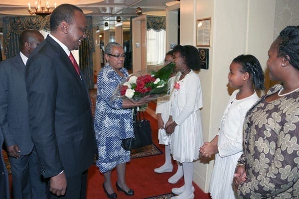 President Uhuru Kenyatta and First Lady Margaret Kenyatta receives a bouquet of flowers from 10 year old Tamasha Mbabu and 9 year old Amelia Muinga on arrival at their residential hotel in New York, US. There is confusion in government on whether the President will be required to attend court at The Hague in person, or if he can do so by video link. PHOTO | PSCU |