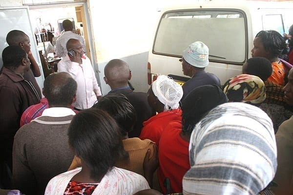 Onlookers at Sagana Health Centre, where Ndia MP Joseph Mushumba's bodyguard and Ngando Primary School headteacher Sammy Mwangi were rushed on September 22, 2014. PHOTO | GEORGE MUNENE | NATION MEDIA GROUP