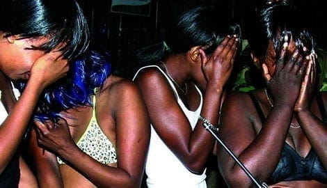 A group of arrested sex workers shy away from the camera. The programme targets HIV and Aids high-risk groups including commercial sex workers and injecting drug dealers.
