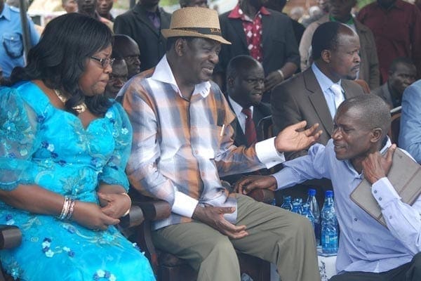 Cord leader Raila Odinga and his wife Ida console Mr Dennis Onyango, the politician’s communications director, at Ageng’a Village in Nyatike, Migori County, during the burial of his father on October 3, 2014. PHOTO | DENISH OCHIENG