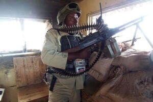 Mutua handles a machine gun at a US military base in Iraq. PHOTO | COURTESY