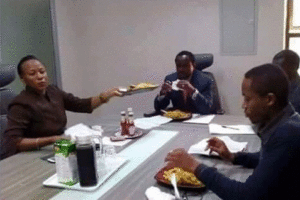 Cord co-principal Kalonzo Musyoka (center) shares a meal of chips with a group of youth in his office.