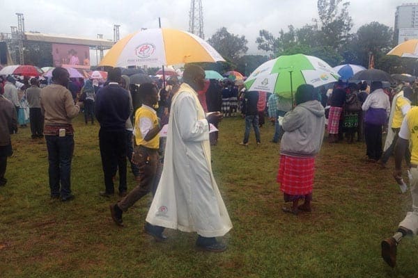 Priests walking in the crowds distributing sacrament to the masses. PHOTO | EUNICE KILONZO | NATION MEDIA GROUP