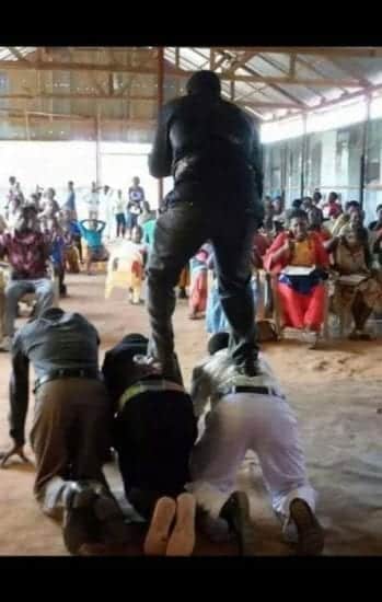 The Tanzanian clergyman delivers a sermon while standing on the backs of congregants. 