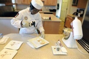 Navy Petty Officer 1st Class Frida Karani, 2016 Armed Forces Chef of the Year and personal chef for the vice chairman of the Joint Chiefs of Staff, adds the finishing touches to the topping as she creates a lemon meringue tart dessert at the vice chairman’s Fort Myer, Virginia, residence, March 24, 2016. DoD photo by Marvin Lynchard