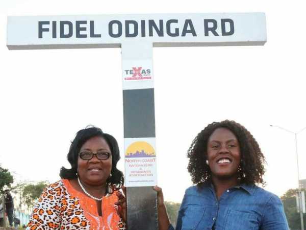 Ida Odinga and Winnie Odinga stand next to the road sign in Nyali, Mombasa. The road was named after the late Fidel Odinga. /ELKANA JACOB 