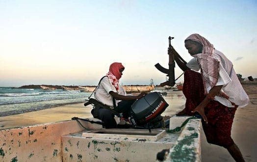 In this photo taken on January 4, 2010, armed Somali pirates carrying out preparations to a skiff in Hobyo, northeastern Somalia, ahead of attacks on ships sailing in the Gulf of Aden. AFP PHOTO