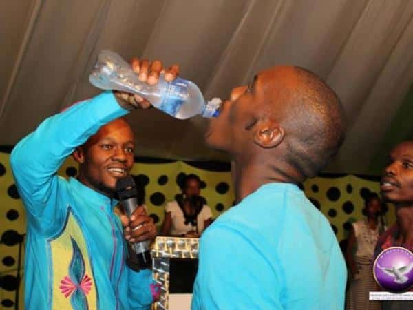 Pastor Light Monyeki feeding a congregant the mixture of water and 'Rattex'. /THE TIMES