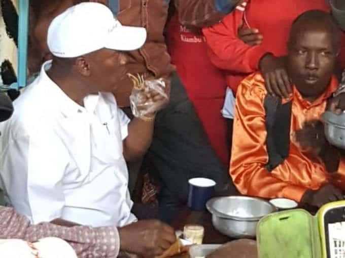 Kiambu Governor William Kabogo eats chapati at a local market. /COURTESY