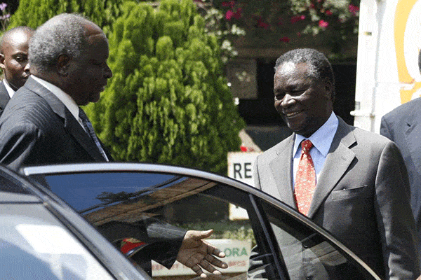 President Mwai Kibaki (left) confers with
