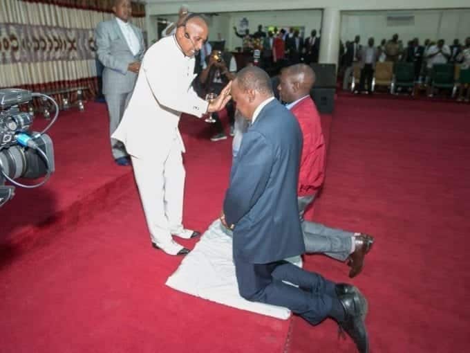 President Uhuru Kenyatta and his Deputy William Ruto being prayed for at Jesus Winners Chapel.