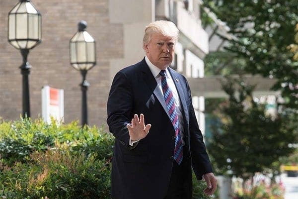 US President Donald Trump waves to the press as he walks out of St John's Episcopal Church in Washington, DC, on September 3, 2017 after attending a service on the National Day of Prayer for victims of Hurricane Harvey. The president has decided to end a protection program for young undocumented immigrants. PHOTO | NICHOLAS KAMM | NATION MEDIA GROUP