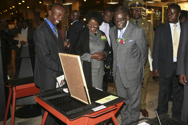 Zimbabwean President Robert Mugabe inspects a vendor’s stand on the sidelines of a business forum on small and medium enterprises (SMEs) held at a hotel in Harare, capital of Zimbabwe. PHOTO | XINHUA | FILE