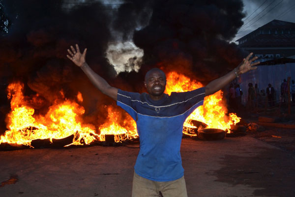 A man takes part in a demonstration along Olympic road in Nairobi on December 3, 2013 over a plan by the government to issue title deeds in Kibera to members of the Nubian community. PHOTO | JEFF ANGOTE