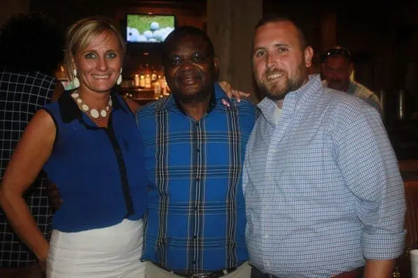 Ambassador Robinson Githae poses for a photo with Rock Creek Resort restaurant staff Stephanie Martin (left) and Steve Layton in Dallas, Texas during a business dinner organised for Kenyan in the diaspora. Mr Githae told Nation that voter registration for Kenyan diaspora will start in March 2017. PHOTO | CHRIS WAMALWA | NATION MEDIA GROUP
