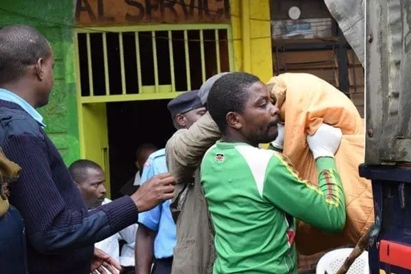 Nyeri Man commits suicide Police personnel load onto a van the body of a