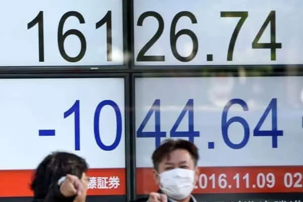 Businessmen talk before an electronic quotation