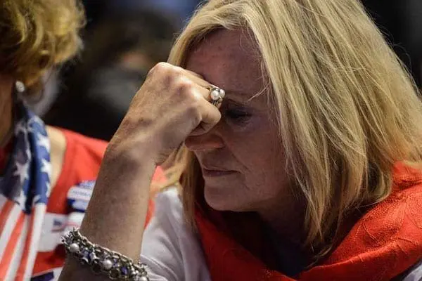 A supporter of Hillary Clinton reacts as she