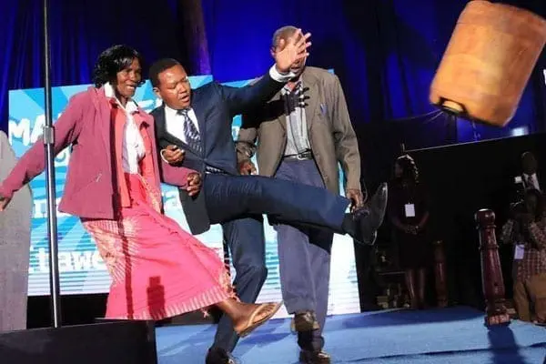 Machakos Governor Alfred Mutua Machakos Governor Alfred Mutua (centre) kicks a water jerrican to symbolise kicking away poverty during the launch of Maendeleo Chap Chap party on August 25, 2016 at Bomas of Kenya. PHOTO | JEFF ANGOTE | NATION MEDIA GROUP