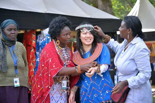 6th Tokyo International Conference A delegate is fitted with traditional Maasai