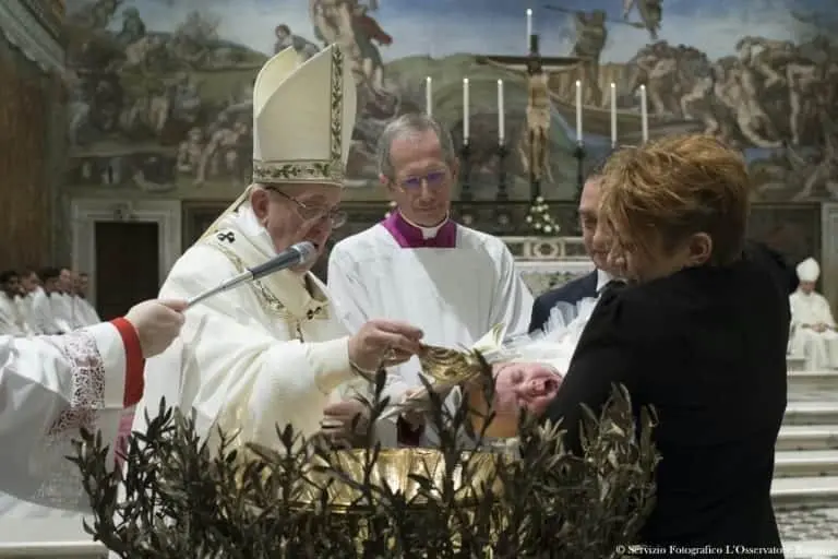 Pope Francis baptises a baby