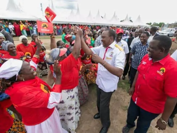 President Uhuru Kenyatta,deputy and Kwale governor Salim Mvuray interact with residents of Lunga Lunga on arrival for a public rally in Lunga Lunga, Kwale County yesterday./PSCU