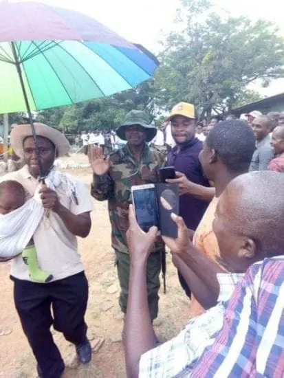 Some Kenyan men strapped children on their back to jump queues
