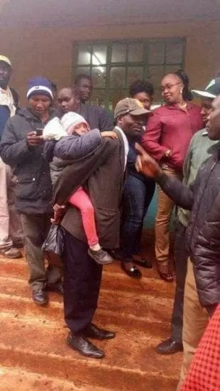 Some Kenyan men strapped children on their back to jump queues