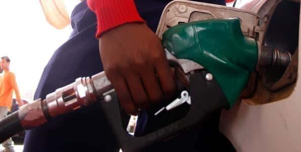 An attendant fuels a car at a petrol station. Statistics from the KNBS show that lower cost of fuel was the major cause of the drop in the overall cost of living. FILE