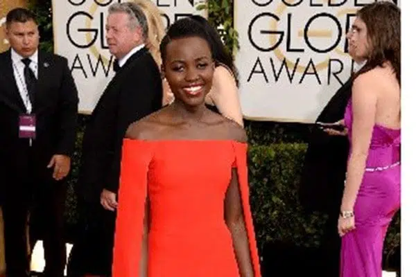  Actress Lupita Nyong'o attends the 71st Annual Golden Globe Awards held at The Beverly Hilton Hotel on January 12, 2014 in Beverly Hills, California. Lupita Nyong'o, a best supporting actress nominee for her searing turn in "12 Years A Slave," stunned in a red Ralph Lauren column dress with matching cape, baring her toned shoulders. AFP PHOTO