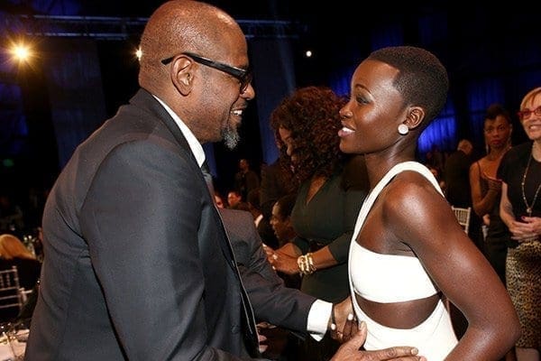 Actor Forest Whitaker (L) and Kenya's Lupita Nyong'o attend the 19th Annual Critics' Choice Movie Awards at Barker Hangar on January 16, 2014 in Santa Monica, California. Lupita’s razor-cut hair was by Larry Sims, former choreographer to Missy Elliot now turned hair stylist to Queen Latifah, the Beckhams, Gabrielle Union, Mary J. Blige and iconic black magazines Ebony and Essence. Photo/Christopher Polk/Getty Images/AFP