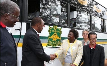 President Uhuru Kenyatta presents the new bus to State House Girls High School principal Mrs J.R. Muoti on July 25, 2014.