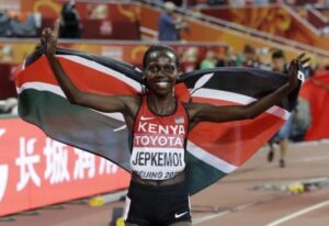 Kenya's Hyvin Kiyeng Jepkemoi celebrates after winning the gold medal in the women's 3000m steeplechase final at the World Athletics Championships at the Bird's Nest stadium in Beijing, Wednesday, Aug. 26, 2015. (AP Photo/Lee Jin-man)
