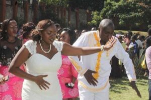 QTV reporter Ken Murithi and his bride Diana Amunga Ochami dance at their wedding reception at Loreto Convent Valley Road in Nairobi. PHOTO | WACHIRA MWANGI