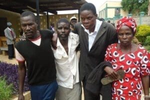 Mr Saleh Wanjala, (in white shirt) accompanied by his Aunt, Evelyn Namusia and other family members leave the Bungoma Court on May 20, 2016 after he was released on a Sh30,000 cash bail. Mr Wanjala was charged with endangering his life by hanging on a helicopter. PHOTO | RAPHAEL WANJALA | NATION MEDIA GROUP