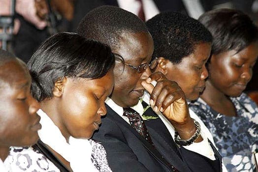 Mr Hosea Kili (centre), the father of the late Careen Chepchumba, sits with other family members during her requierm mass at the Seventh Day Adventist Church in Nairobi, February 23rd, 2012. PHOTO | FILE