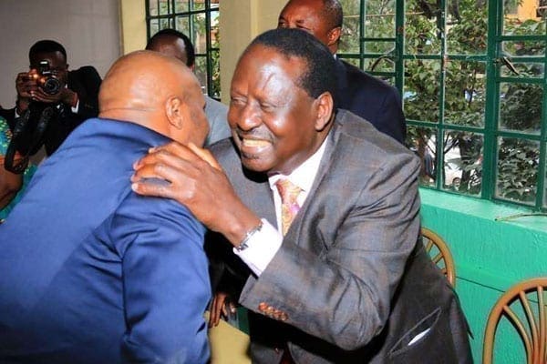 Cord leader Raila Odinga embraces Gatundu South MP Moses Kuria before a lunch event at the Ranalo Foods restaurant in Nairobi on June 21, 2016.