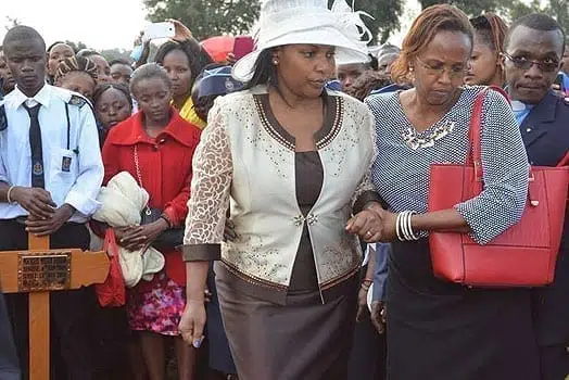 Hanna Wariaria is assisted by a relative during the funeral. 