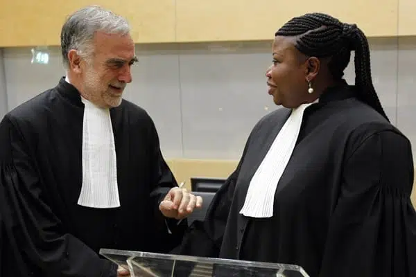 Former International Criminal Court's chief prosecutor Luis Moreno-Ocampo (left) speaks with his successor Ms Fatou Bensouda after her swearing-in ceremony as the new chief prosecutor in The Hague, on June 15, 2012. PHOTO | AFP