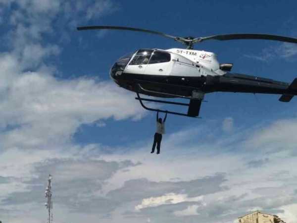 Saleh Wanjala hanging on the helicopter in BungomaPHOTOS/FILE