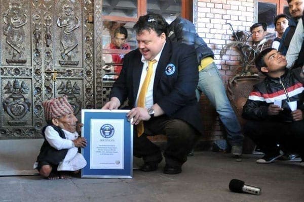 Chandra Bahadur Dangi (left), a 72-year-old Nepali is presented with a certificate by a Guinness World Records official after being declared the world's shortest man at 54.6 centimetres (21.5 inches) tall in Kathmandu on February 26, 2012. Kenyans have become shorter or stagnated in the past 100 years compared to their peers around the globe, especially those in Europe. PHOTO | AFP