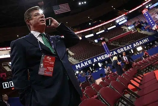 Paul Manafort, Campaign Manager for Donald Trump, speaks on the phone while touring the floor of the Republican National Convention at the Quicken Loans Arena as final preparations continue July 17, 2016 in Cleveland, Ohio. PHOTO | AFP