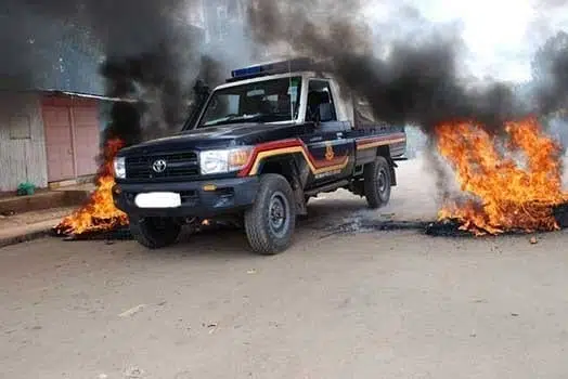 A police vehicle is driven fast between burning tyres in a past incident. PHOTO | FILE